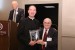 Dr. Nagib Callaos, General Chair, giving Fr. Prof. Joseph Laracy a plaque "In Appreciation for Delivering a Great Keynote Address at a Plenary Session."